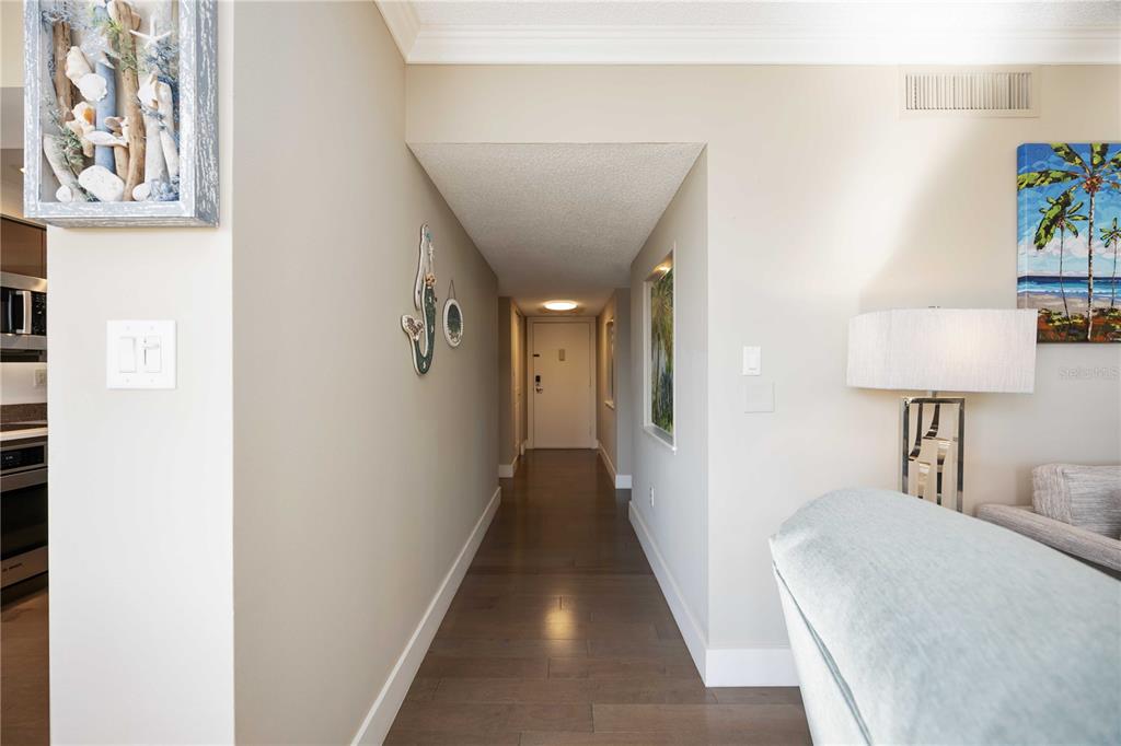 1050 Longboat Club Road, Unit 204 Longboat Key, FL 34228 - Photo 10 of 64 a view of a hallway to a livingroom with furniture and a lamp
