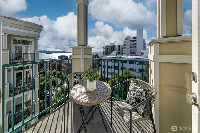 a balcony with table and chairs