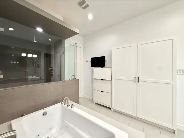 a bathroom with a bathtub and a sink