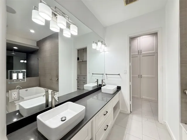 a bathroom with a double vanity sink and a mirror