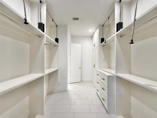 a bathroom with a double vanity sink and shower