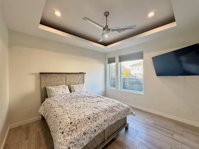 a bedroom with a large bed and a flat screen tv