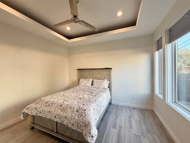 a bedroom with a bed and a large window