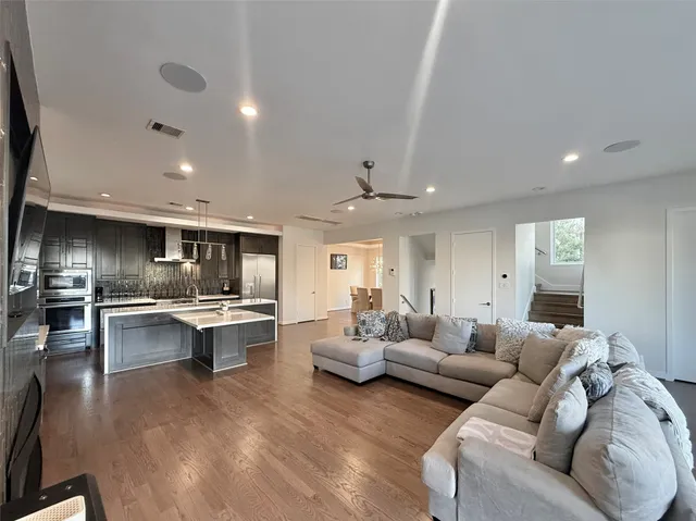 a living room with furniture and view of kitchen