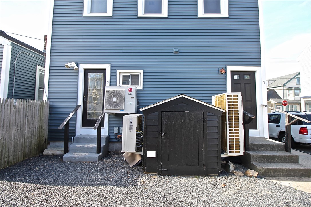 668 Thames Street, Unit 2 Newport, RI 02840 - Photo 35 of 42 Rear View from yard to private back door for 1st floor, bulkhead to basement and back door for apt 2&3