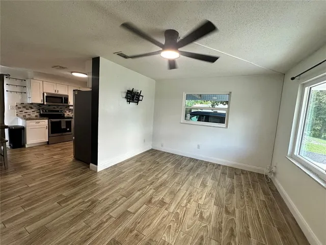 a view of a kitchen with a dishwasher cabinets and a large window