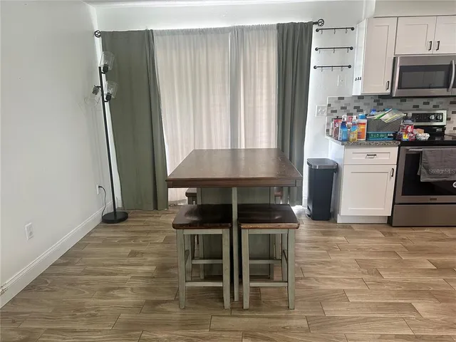 a kitchen with furniture a refrigerator and a stove