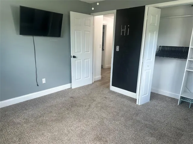 a view of an empty room with a bathroom