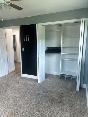 a view of an empty room with a closet