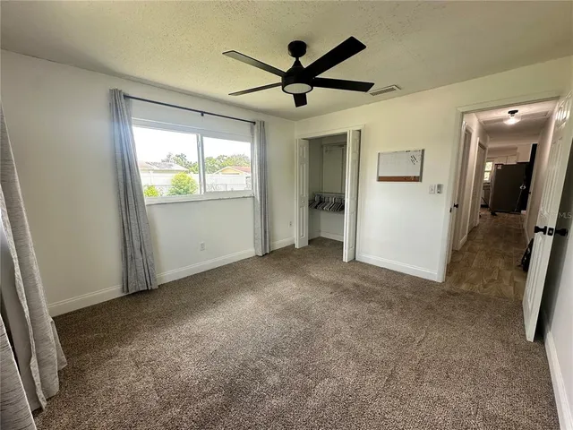 a view of a livingroom with a ceiling fan and a window