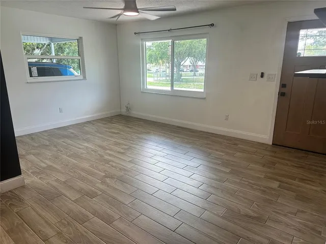 wooden floor in an empty room with a window