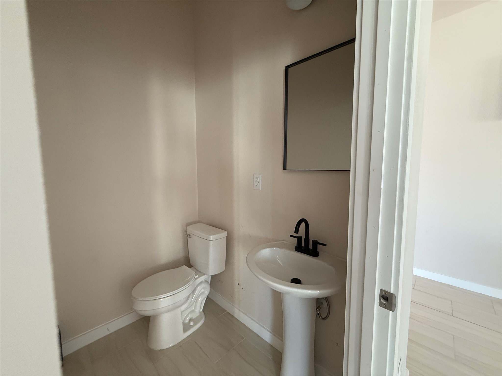 219 South 7th Street Beasley, TX 77417 - Photo 22 of 23 a white toilet sitting next to a bathroom sink