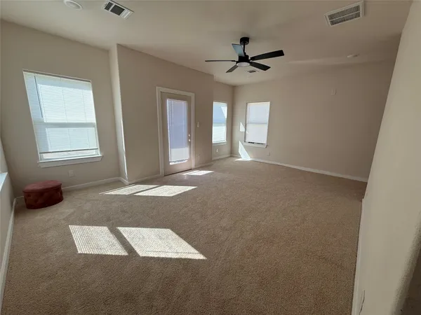 a view of a balcony with a door and wooden floor