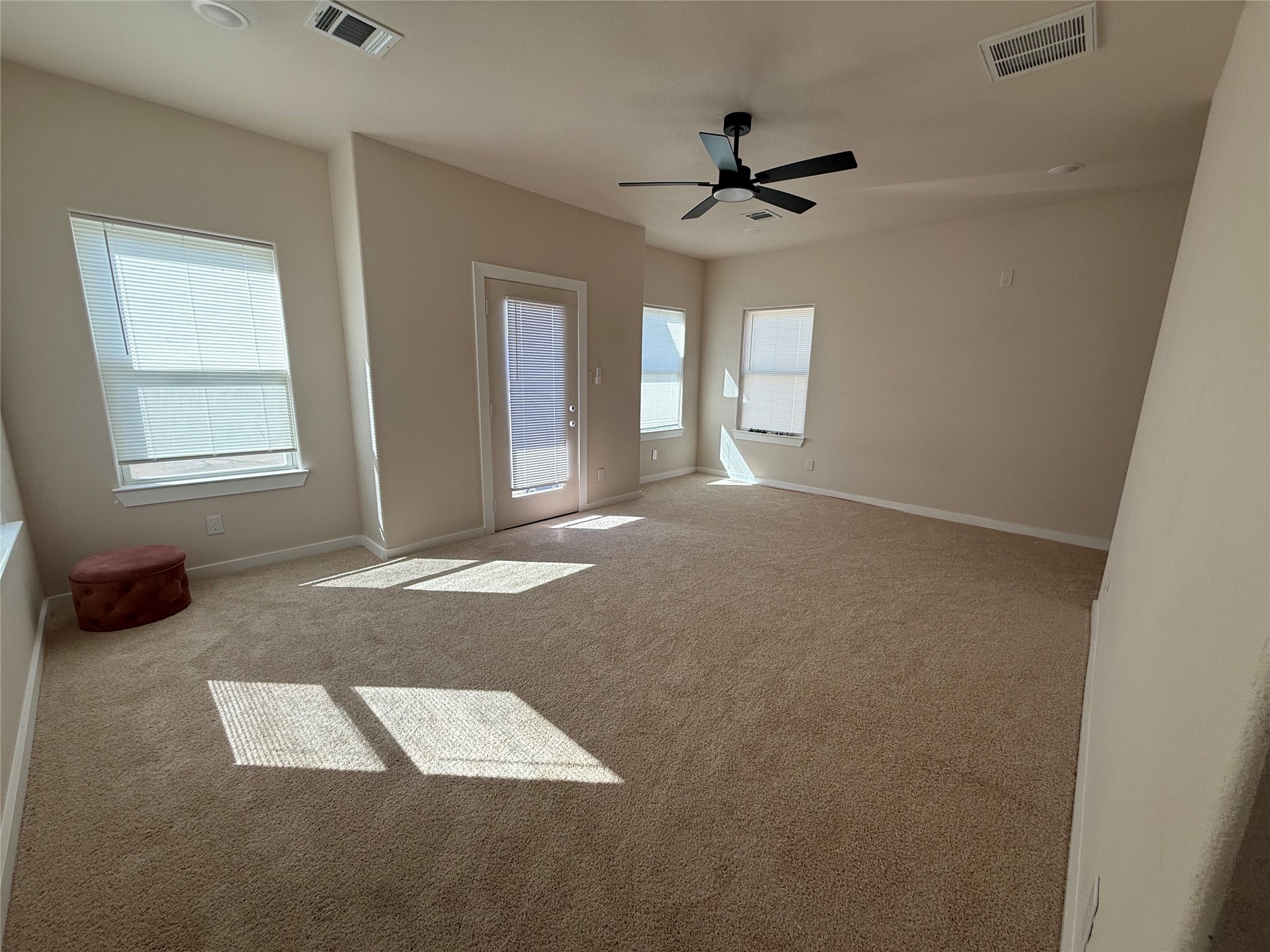 219 South 7th Street Beasley, TX 77417 - Photo 6 of 23 an empty room with windows and ceiling fan