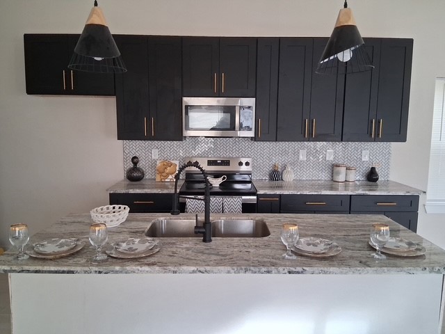 219 South 7th Street Beasley, TX 77417 - Photo 8 of 8 a kitchen with a sink and cabinets