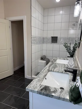 a bathroom with a sink a toilet and a mirror