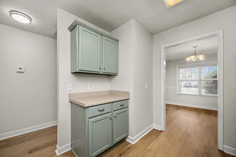 a view of a kitchen with wooden floor and window