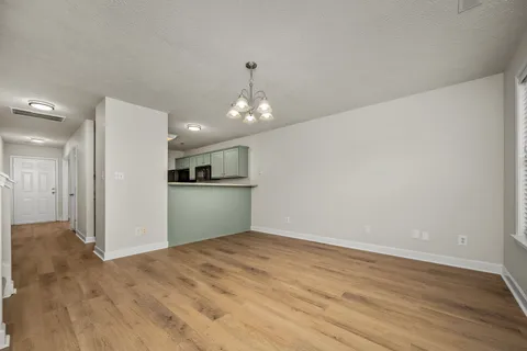 a view of a kitchen with a sink and a refrigerator