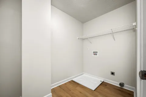 a view of a room with wooden floor