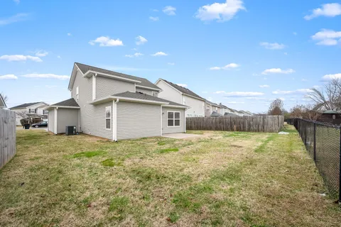 a view of a house with a yard and garage