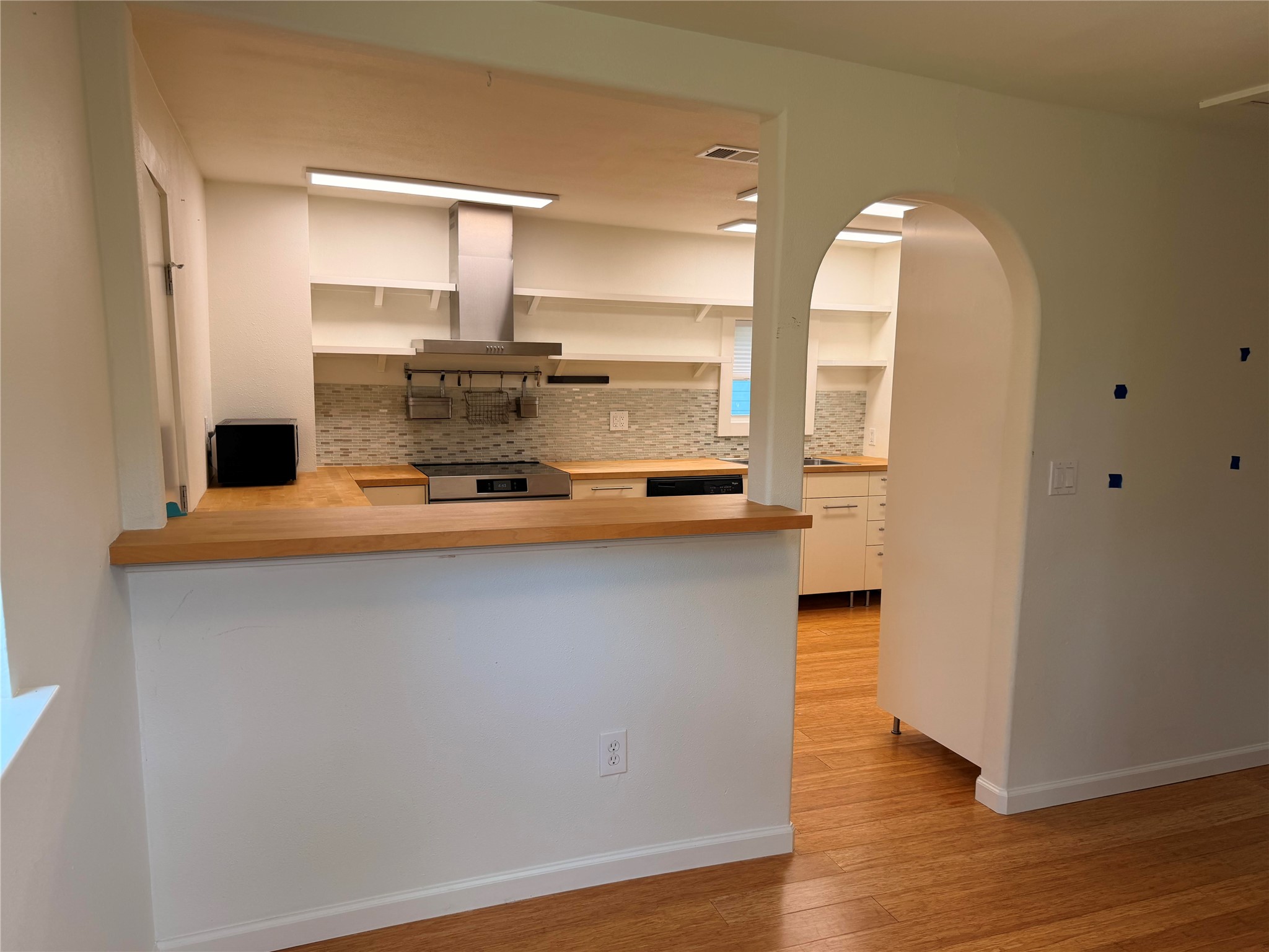 1182 Pandora Street Austin, TX 78702 - Photo 10 of 19 A well-equipped kitchen with stainless steel appliances and natural wood countertops, perfect for culinary endeavors.