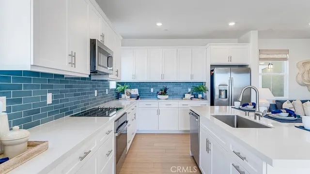 a kitchen with a sink cabinets and appliances