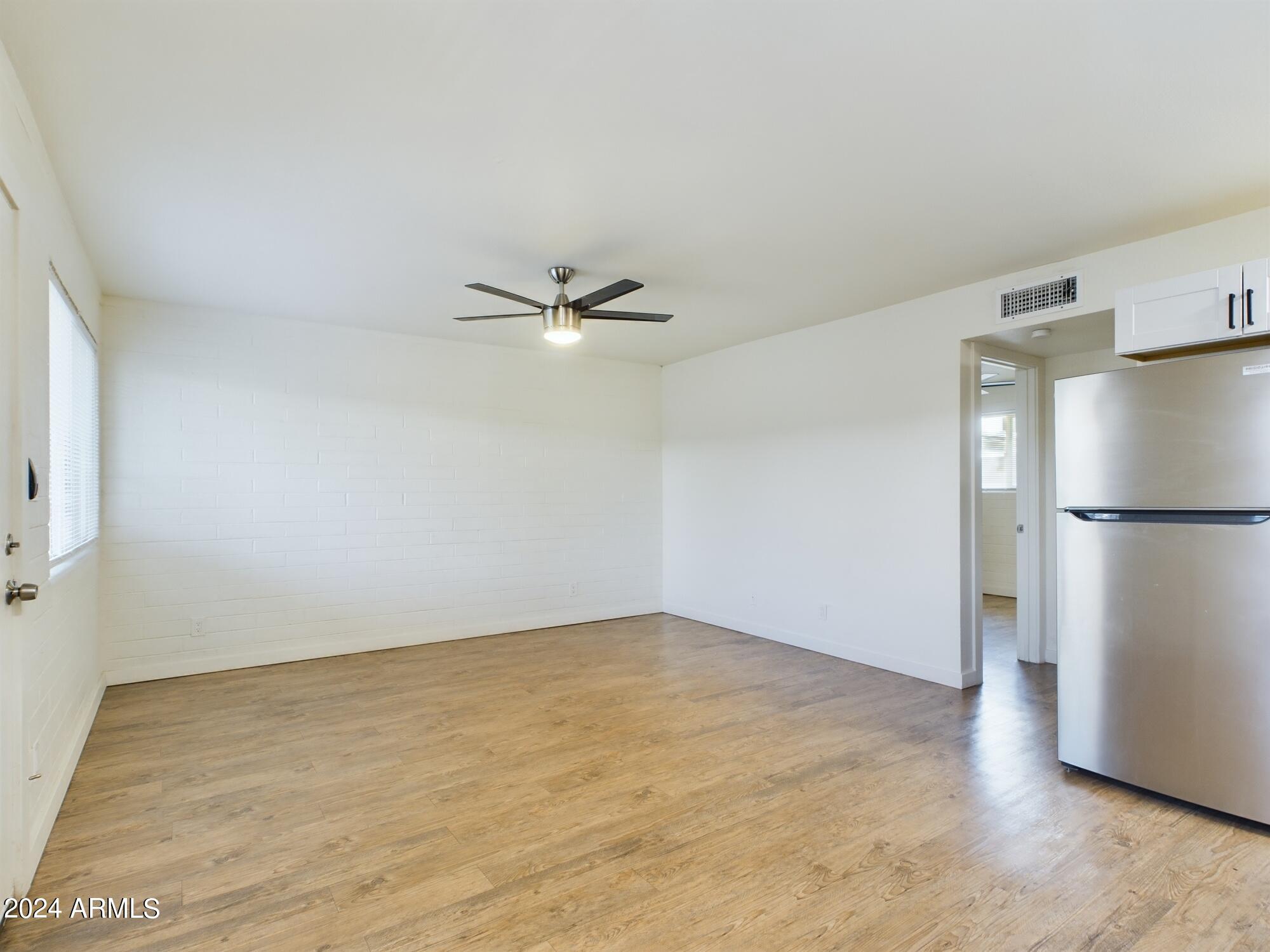 3027 North 37th Street, Unit 3 Phoenix, AZ 85018 - Photo 4 of 12 a view of a kitchen with a sink and a refrigerator