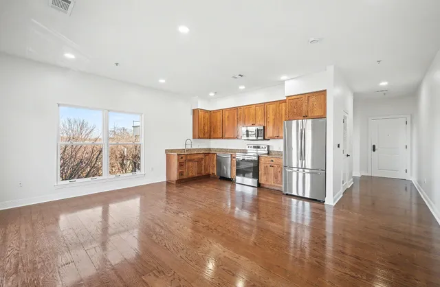 a kitchen with stainless steel appliances a refrigerator and a stove top oven