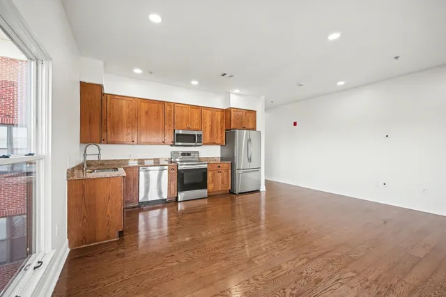 a kitchen with stainless steel appliances a refrigerator and a stove top oven