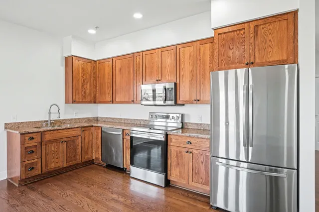 a kitchen with appliances a sink and a microwave