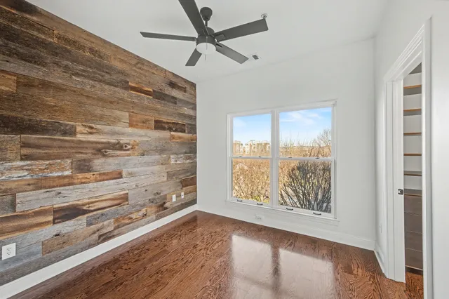 a view of water heater room with wooden floor