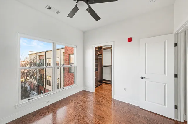 a view of walk in closet with empty racks