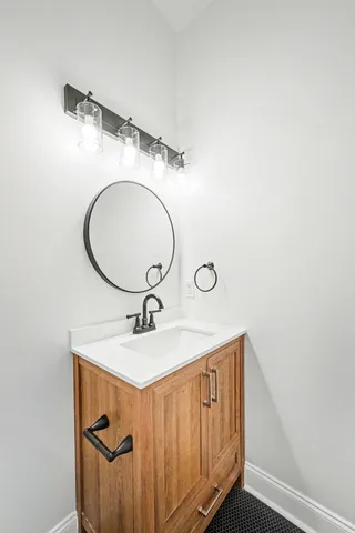 a bathroom with a sink toilet a mirror and shower
