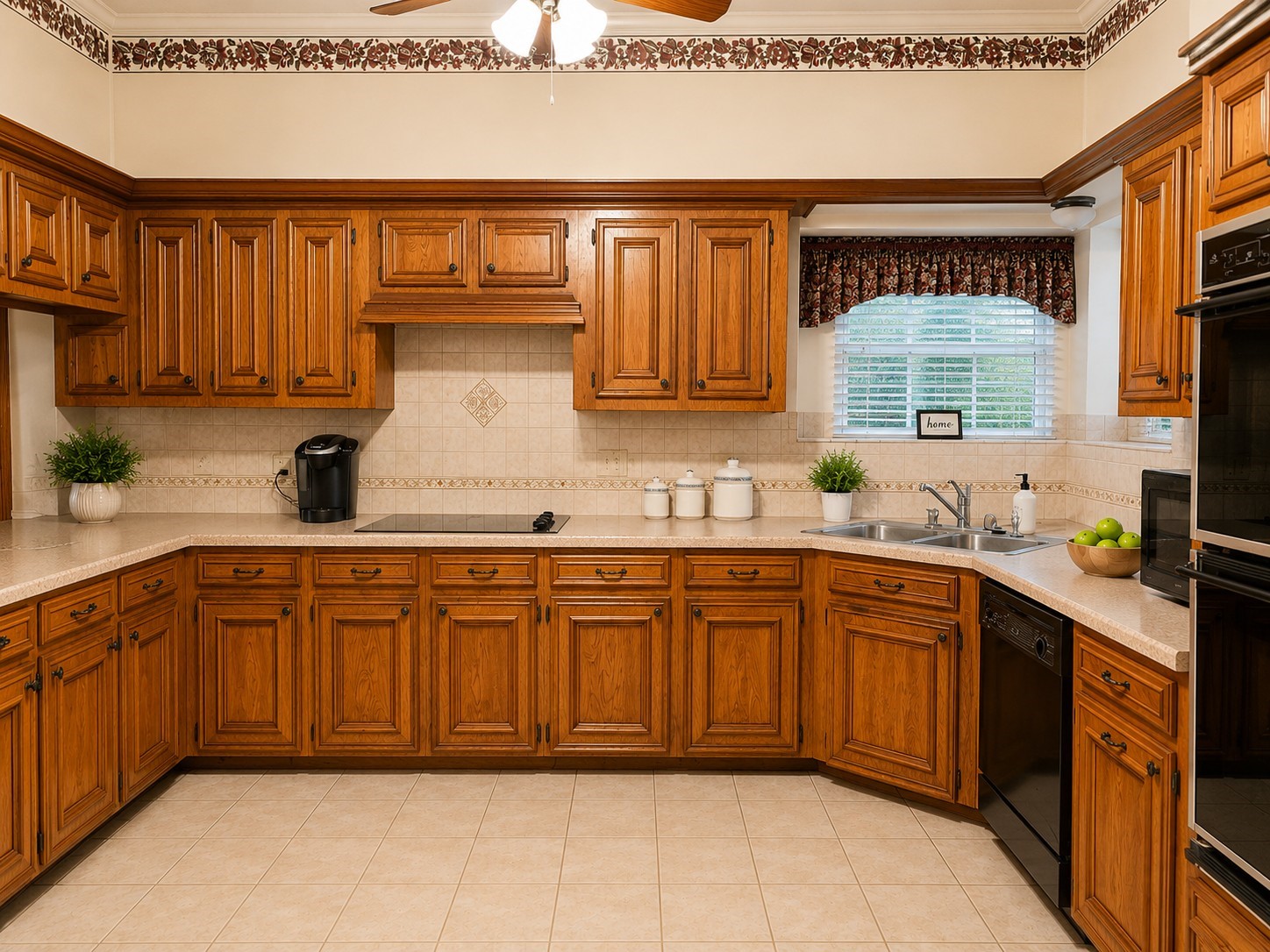 5518 Lacreek Lane Spring, TX 77379 - Photo 4 of 29 KITCHEN - Generous kitchen showcases extensive wood cabinetry, abundant counter space, tile flooring and backsplash, a smooth cooktop, double sink, and built-in appliances—all arranged in a spacious, functional layout.