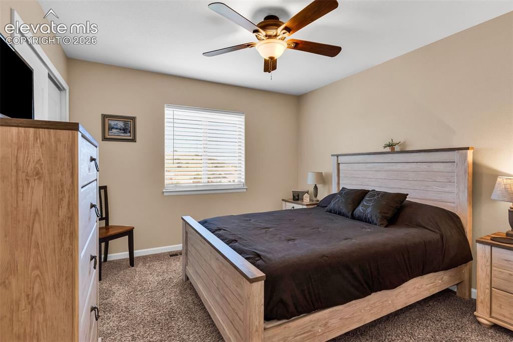 415 Empire Road Canon City, CO 81212 - Photo 30 of 40 a bedroom with a bed and a chandelier