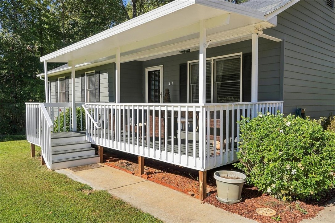 211 Cedar Ridge Drive Westminster, SC 29693 - Photo 4 of 34 A welcoming front porch with white railings highlights this classic home exterior.