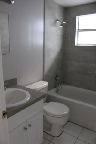 a bathroom with a toilet a sink and bathtub
