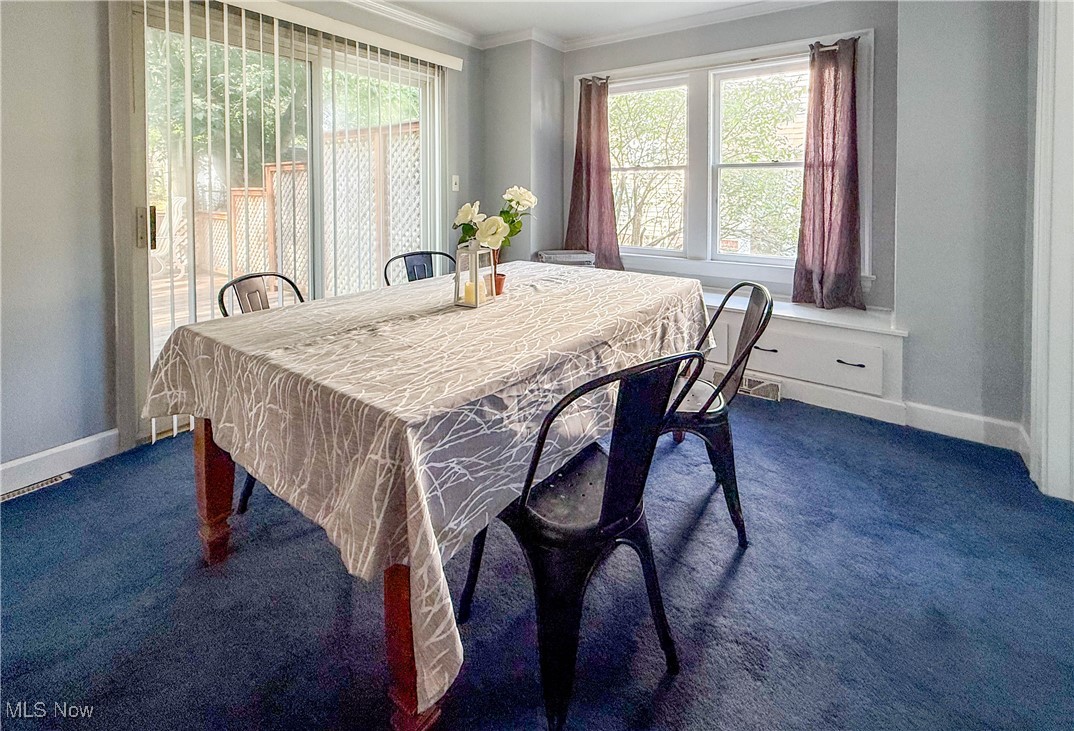 4672 Liberty Road South Euclid, OH 44121 - Photo 6 of 23 Dining area featuring ornamental molding and dark carpet