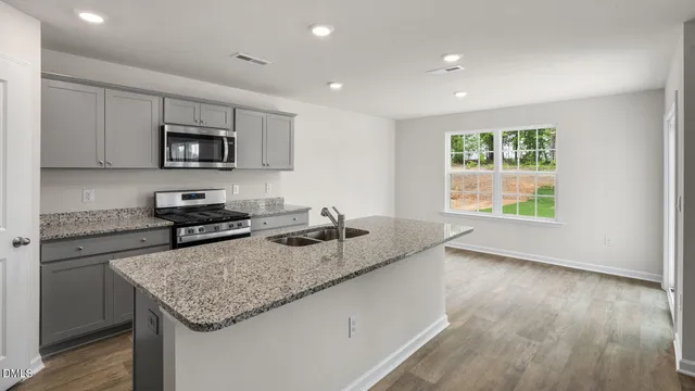 a kitchen with stainless steel appliances granite countertop a sink and cabinets