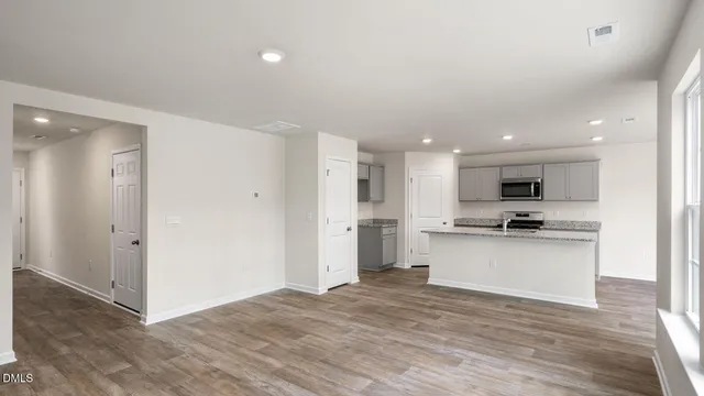 a kitchen with granite countertop a sink and a stove top oven