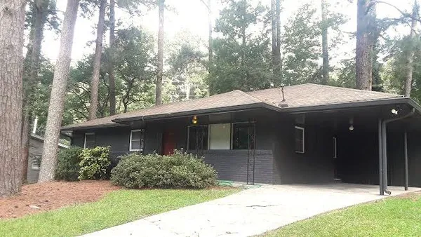 a view of house with outdoor space and garden