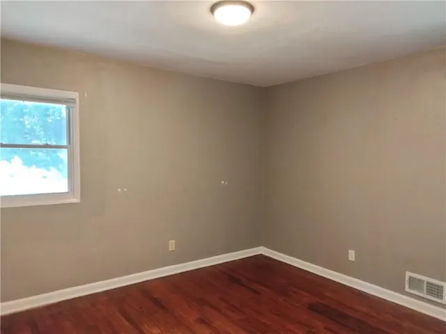 walk in closet with wooden floor