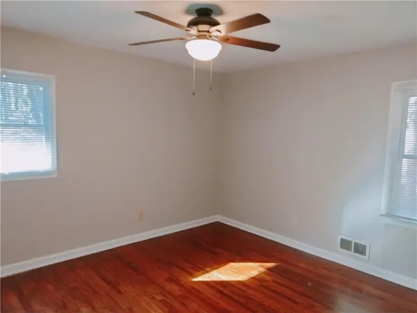 walk in closet with wooden floor