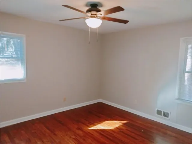 walk in closet with wooden floor