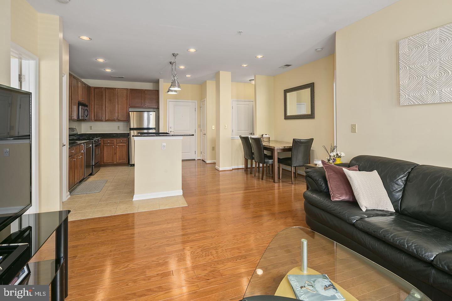 2655 Prosperity Avenue, Unit 108 Fairfax, VA 22031 - Photo 1 of 47 a living room with furniture and kitchen view