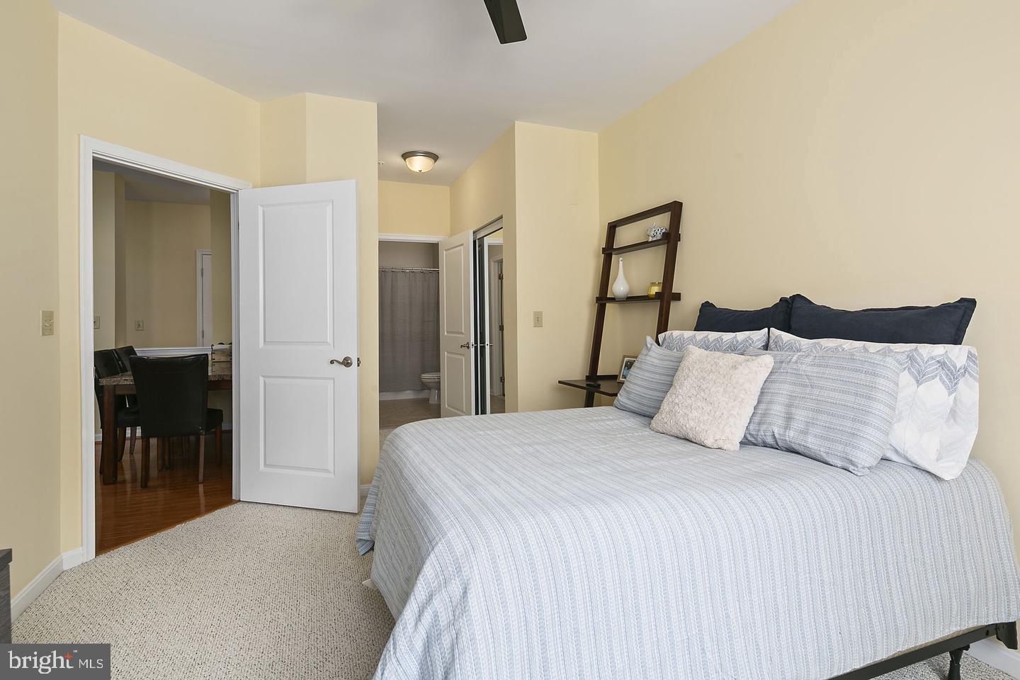 2655 Prosperity Avenue, Unit 108 Fairfax, VA 22031 - Photo 11 of 47 a bedroom with a bed and a table