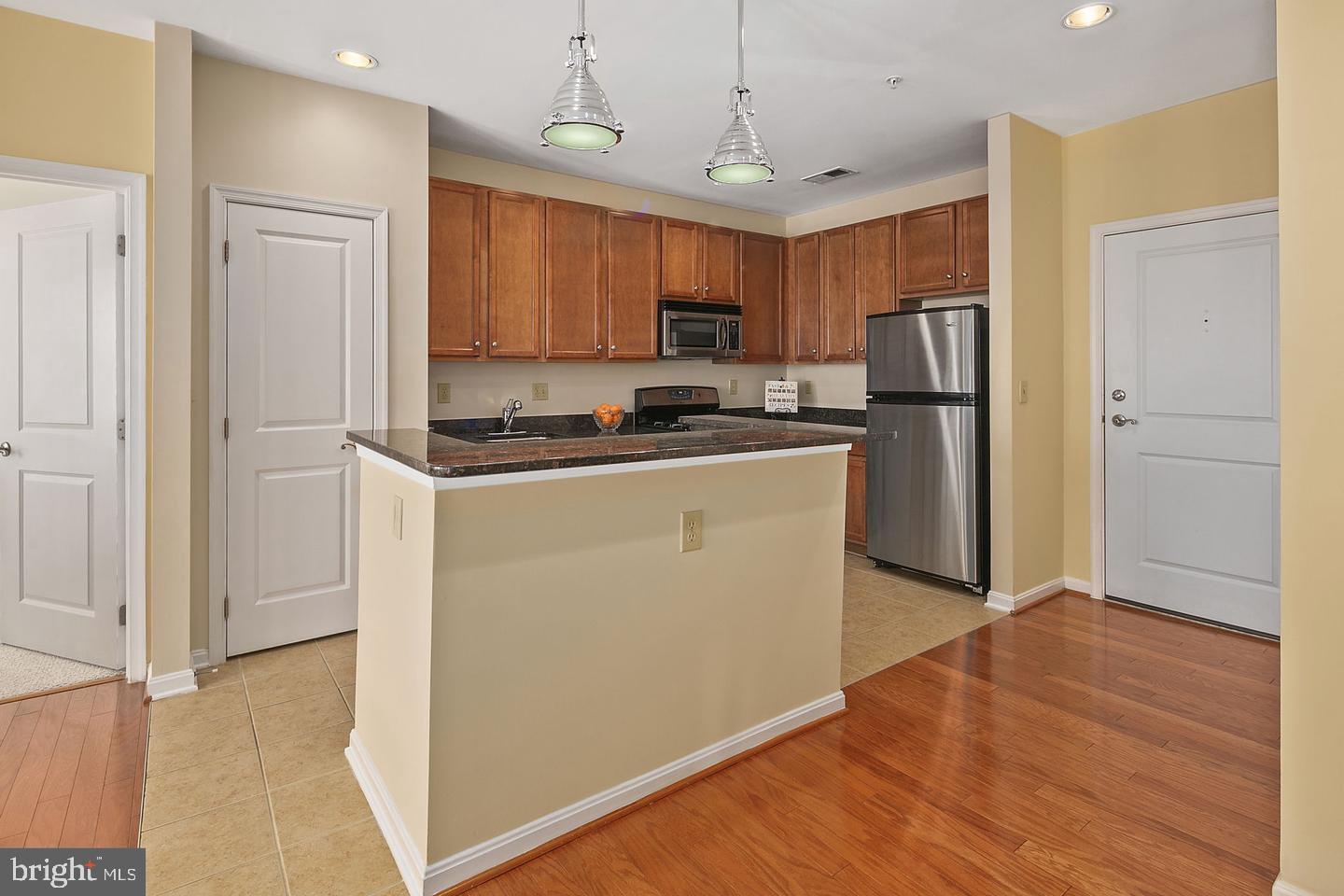2655 Prosperity Avenue, Unit 108 Fairfax, VA 22031 - Photo 16 of 47 a kitchen with stainless steel appliances a refrigerator sink and microwave