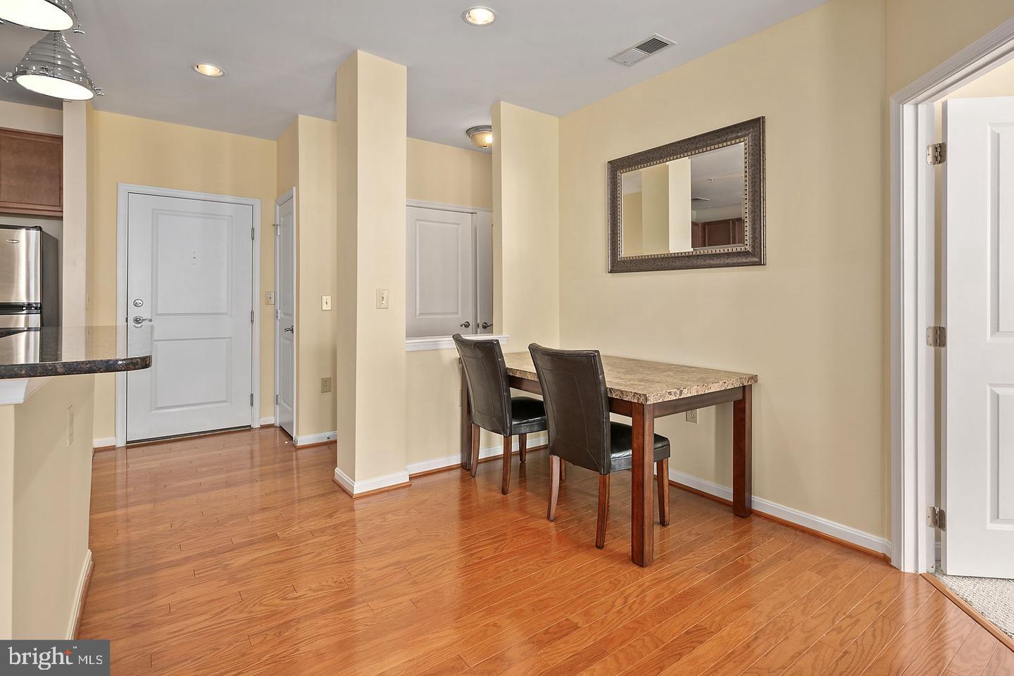 2655 Prosperity Avenue, Unit 108 Fairfax, VA 22031 - Photo 19 of 47 a view of a dining room with furniture and wooden floor