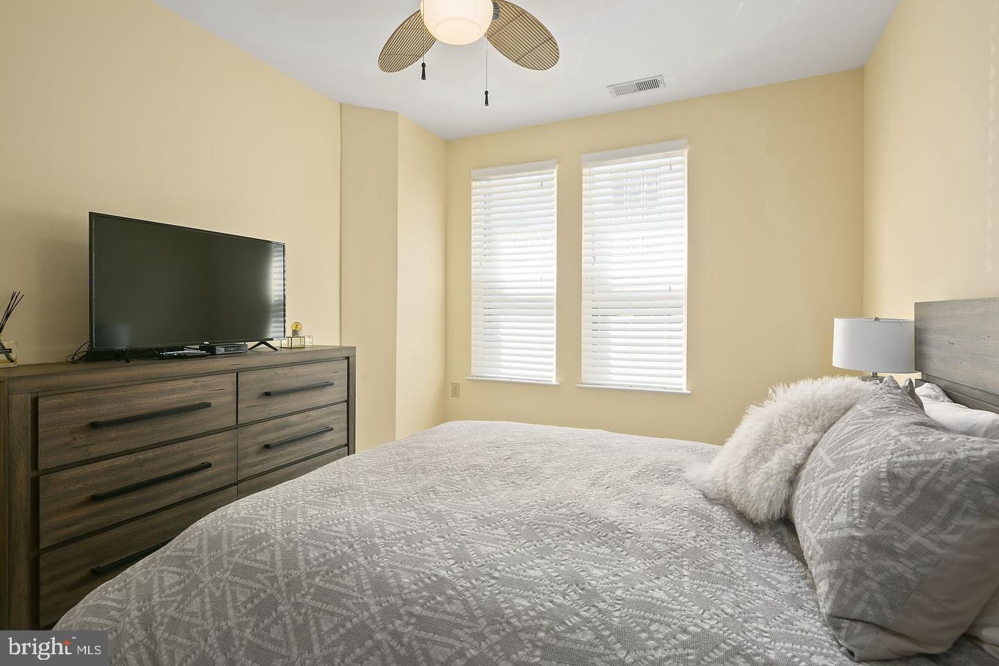 2655 Prosperity Avenue, Unit 108 Fairfax, VA 22031 - Photo 21 of 47 a bedroom with a bed and a flat screen tv