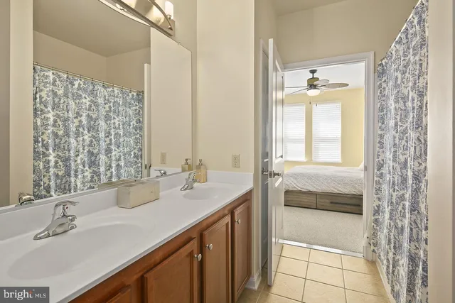 a bathroom with a double vanity sink and a mirror